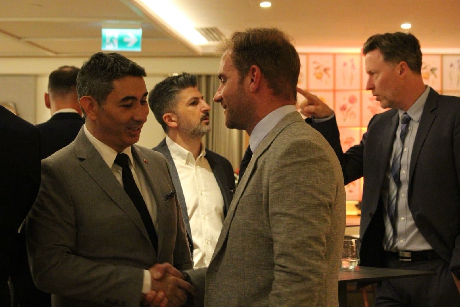 Two guests shaking hands at the reception