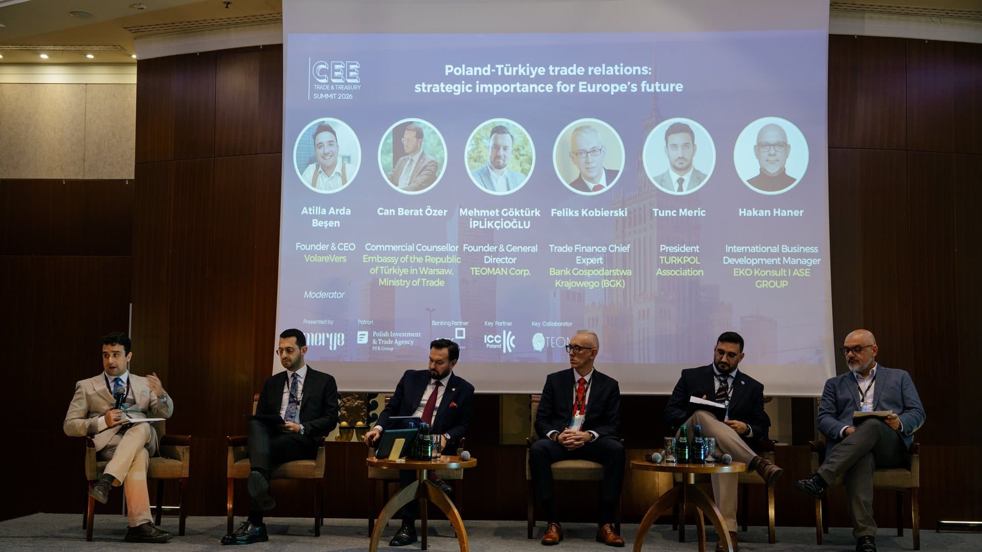Six speakers seated on stage for the Region Highlight on Poland–Türkiye trade relations at the CEE Trade & Treasury Summit 2026, their names and photos on the screen behind them.